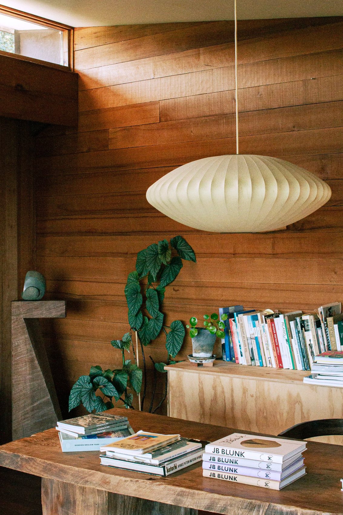 Mid-century interior with a bubble lamp and bookshelf