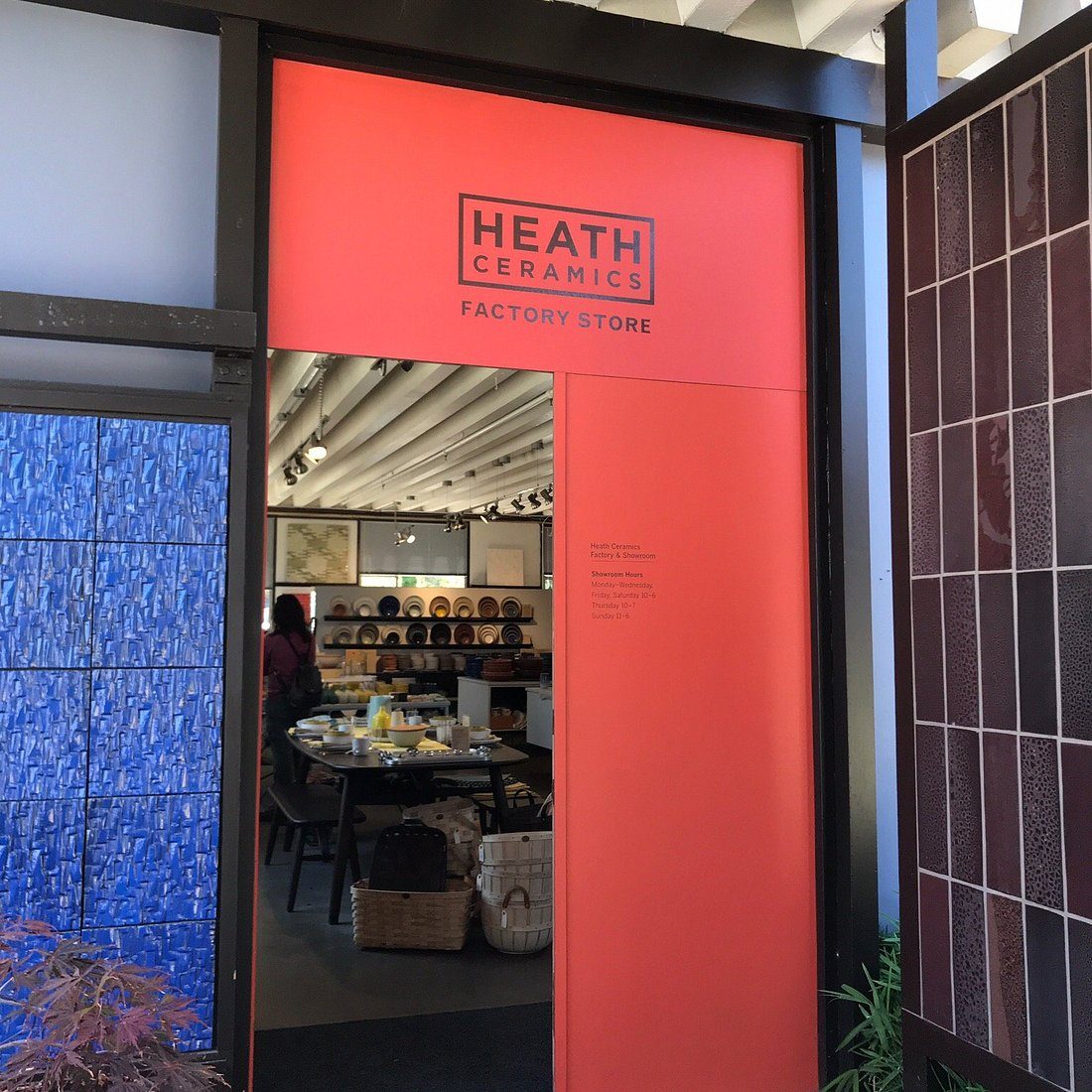 The red entrance of the Heath Ceramics factory store in Sausalito, framed by blue and dark tile walls