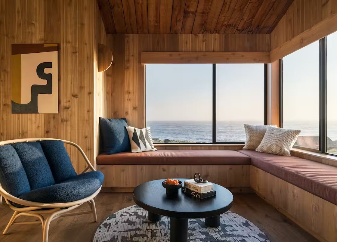 A wood-lined window seat looking out to the ocean