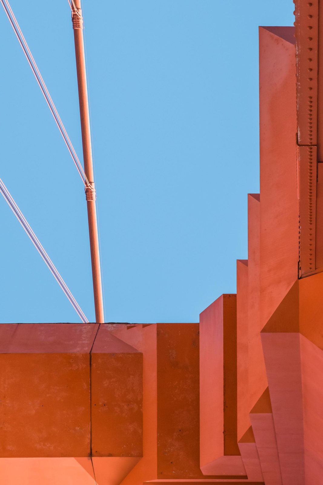 Looking straight up the orange structure of a Golden Gate Bridge tower