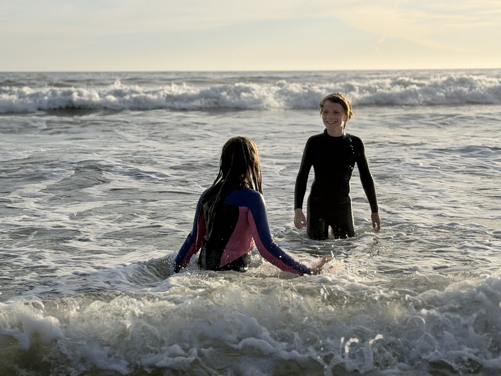 Two young surfers in the white water at Stinson Beach